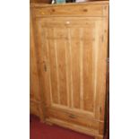 A rustic pine single door armoire, having single long lower drawer, w.102cm