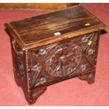 An early 20th century relief carved oak small hinge topped chest, with brass end carry handles, w.