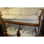 A contemporary Ercol mid-elm slatted three-piece suite, comprising; three-seater sofa and pair of