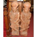 A large pair of Indian relief carved and stained hardwood freestanding ceremonial figures, each h.