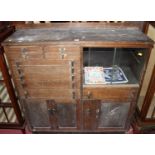 A mid-20th century oak ledgeback dentist's cabinet, having an arrangement of numerous drawers over