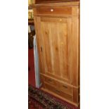 A rustic pine single door armoire, having two short over single long lower drawer, w.84cm