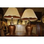 A pair of copper shouldered table lamps (with shades)