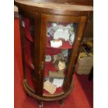 A small table top glazed display cabinet containing a quantity of miniature collectable china, to