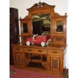 A late Victorian floral carved burr oak mirrorback sideboard, the bevelled mirrorplates over an