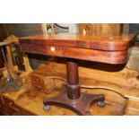 An early Victorian mahogany and satinwood crossbanded round cornered fold-over card table, having