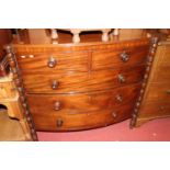 A Regency mahogany bowfront chest of two short over three long drawers, having ring turned