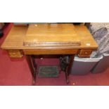 An early 20th century Singer treadle sewing machine table