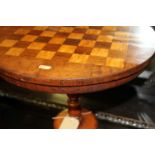 A Victorian mahogany, rosewood and satinwood inlaid chessboard topped circular pedestal games table,