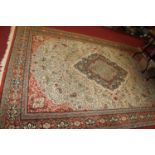 A Persian style European manufactured machine made woollen cream ground Tabriz rug, having