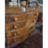 An early 19th century mahogany and flame mahogany bowfront chest, of four long graduated drawers,