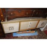 A 1960s laminate and fabric padded inset sideboard, having three central drawers and twin cupboard