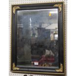 A black and gilt painted rectangular wall mirror, 58 x 46cm