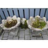 A pair of reconstituted stone floral decorated circular pedestal planters, dia.52cm; together with a