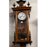 A late 19th century walnut and ebonised Vienna droptrunk wall clock, with pendulum and winding