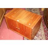 A 1960s teak double door record cabinet, on tapering supports, w.61.5cm