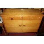 A 1960s light oak veneered sideboard, having twin frieze drawers over conforming lower cupboard