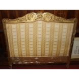 A 19th century carved giltwood and gesso decorated three-quarter sized headboard, with striped