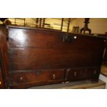 An 18th century provincial close-nailed oak hinge topped mule chest, having twin lower drawers, w.