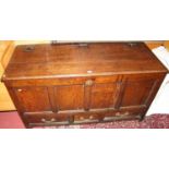 An 18th century provincial joined oak four panelled hinge topped mule chest, having three short