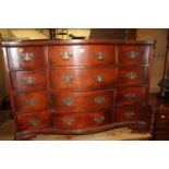A contemporary hardwood serpentine front chest of twelve drawers, w.111cm