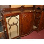 A 1930s mahogany ledgeback part-bowfront china display cabinet, the central panel cupboard door