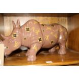 A contemporary composite model of a standing rhino, with applied monograms, length 52.5cm