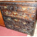 An antique and later relief carved oak squarefront chest of two short over three long graduated