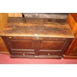 An 18th century joined oak two panelled hinge topped mule chest, having twin short lower drawers,