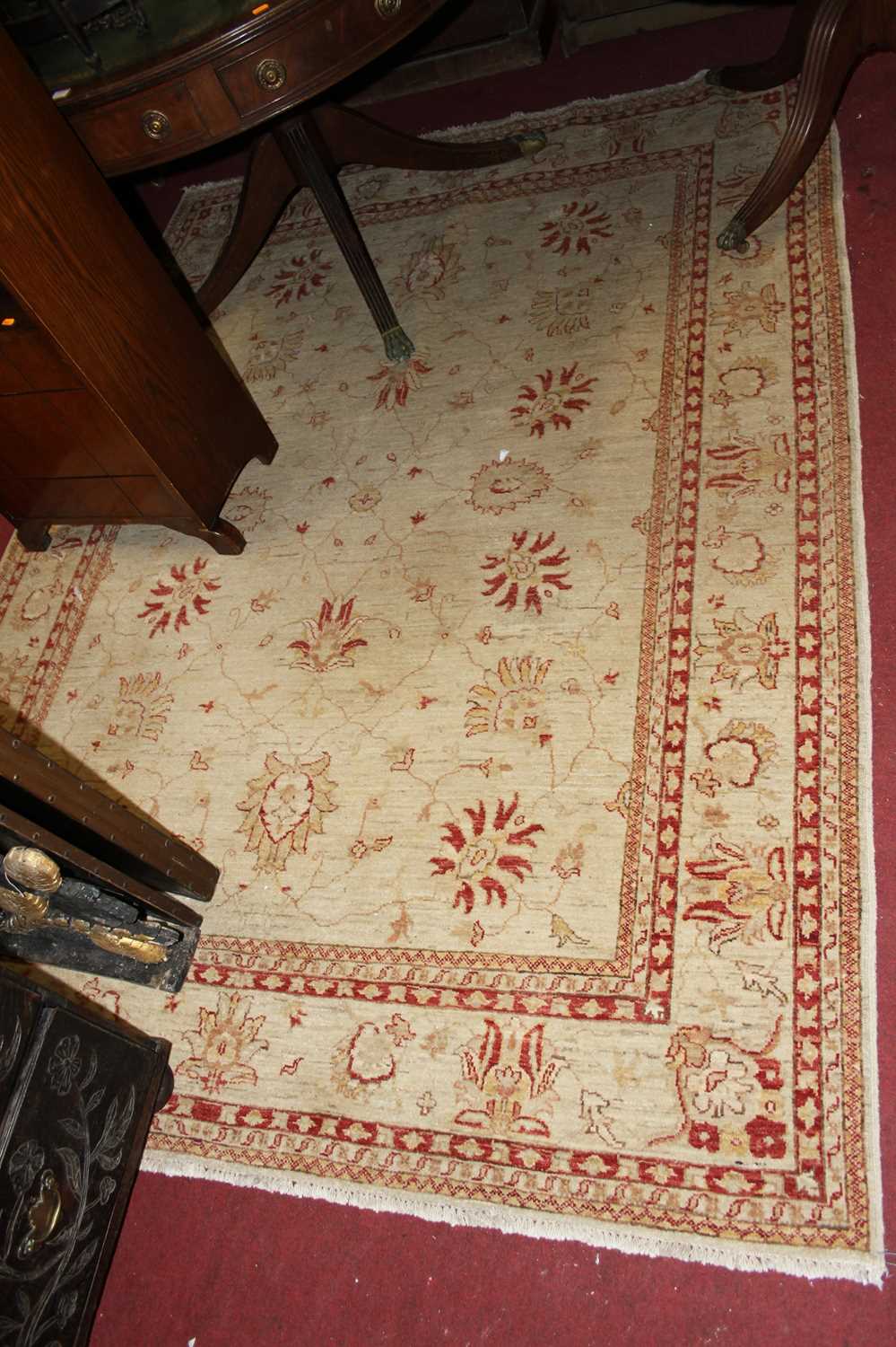 A Persian style machine woven cream ground rug, 240 x 175cm