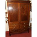 A 19th century mahogany double door wardrobe, with interior hanging space over single long lower