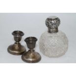 A late Victorian scent bottle having a cut glass body and silver cap, together with a pair of