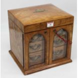 A Victorian olivewood table-top dressing case, with a fitted interior containing four cut glass cent