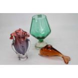 A modern pink tinted art glass vase together with an oversized brandy glass and a figure of a