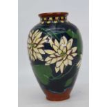 A Charles Wileman Foley Chinaworks vase of baluster form, decorated with flowers in the Intarsio