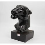 A black painted composite head of a jaguar mounted on a square plinth, height 39cm