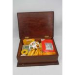 An Edwardian mahogany and satinwood cross banded box, containing a collection of photographic reels,