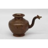 An Indian copper lota water pitcher, having a zoomorphic handle, height 11cm