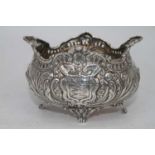 An Edwardian Scottish silver sugar bowl, of boat shape and with pierced border, repousse decorated