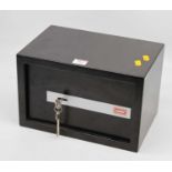 A metal tabletop safe with two keys