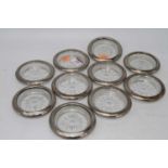 A set of ten Chinese coasters, each having a glass base with silver plated mount