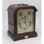 An early 20th century mahogany eight day mantel clock, the silvered dial showing Roman numerals with