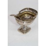 A George III silver caddy spoon, having a shell shaped bowl and bright cut engraved stem; together