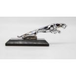 A reproduction Jaguar car mascot mounted upon a black polished hardstone plinth, height 8.5cm