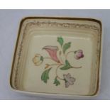 A 1930s Clarice Cliff pottery dish of square shape, handpainted with flowers within gilt border