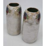 A pair of Royal Doulton stoneware vases each on a mottled grey ground with tubelined floral