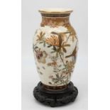 A Japanese Satsuma vase, of baluster form, decorated with birds amongst flowers, on an associated