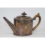 A George III silver teapot, of oval form, having bright cut engraved decoration and fruitwood