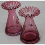 A pair of Victorian style amethyst tinted glass vases, each having a wavy rim to a tapered