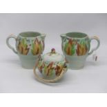 A pair of Clarice Cliff celtic leaf and berry jugs, height 19cm, together with a matching jar and